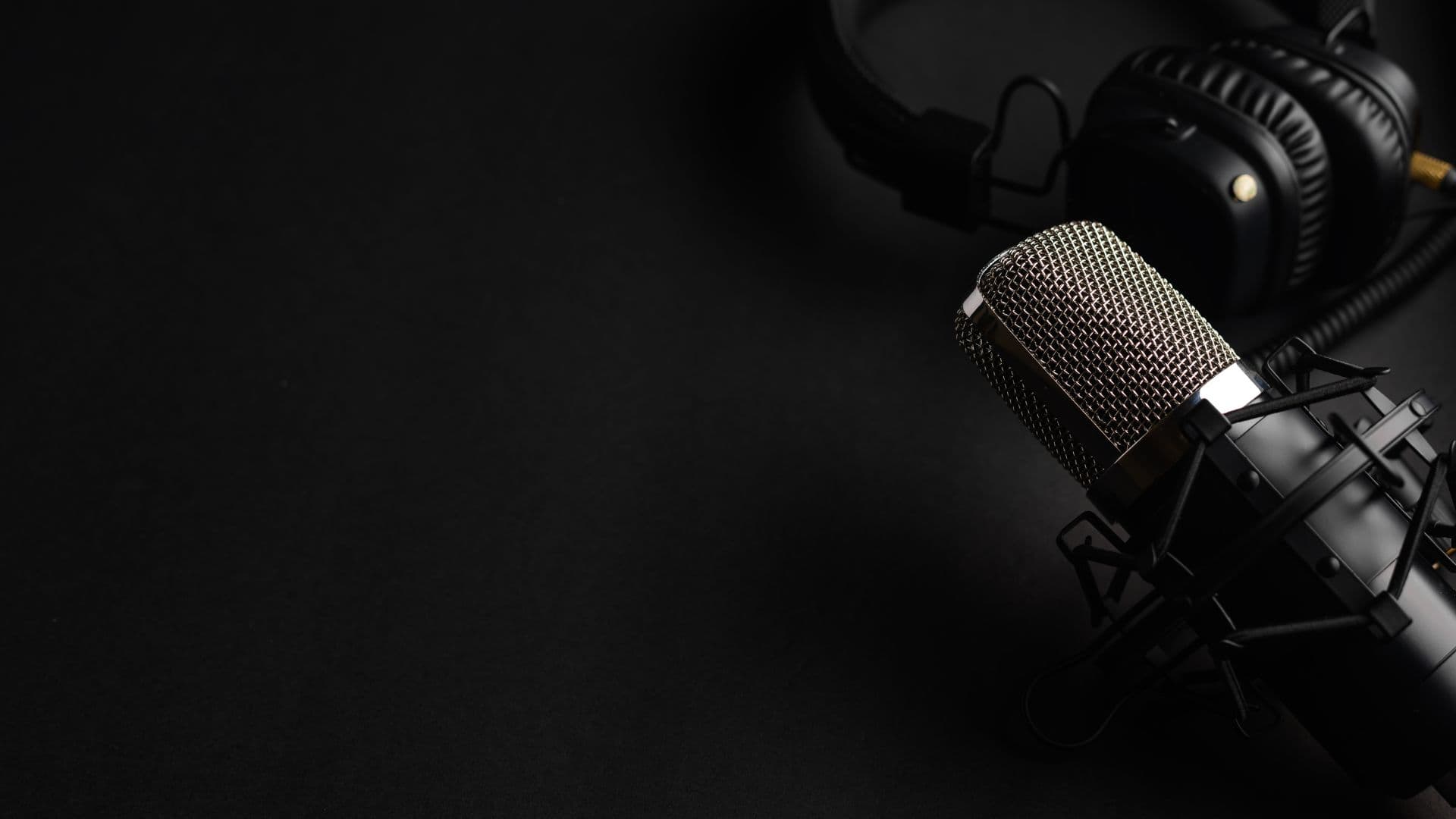 Broadcast microphone on a boom arm in the sound-treated podcast suite