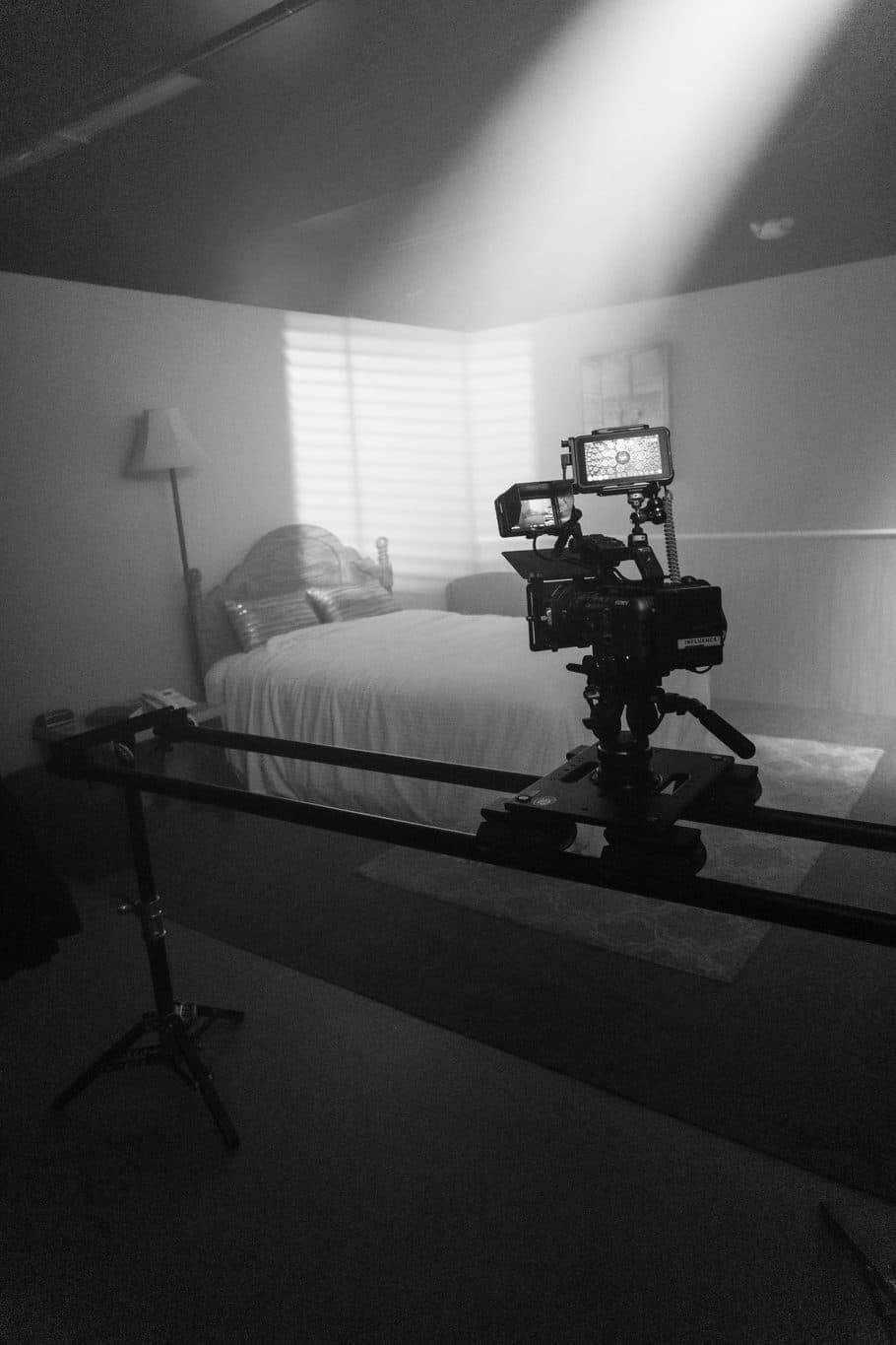 Sony cinema camera on a slider in front of a bedroom set with hazy window light