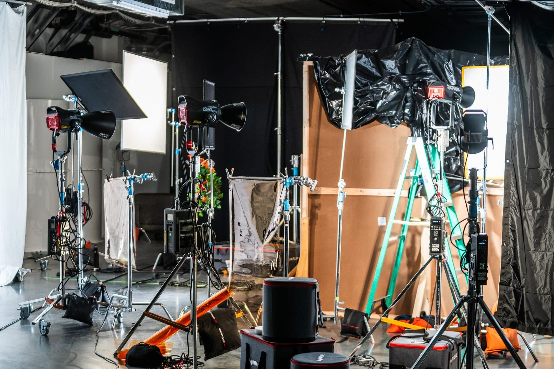 Aputure Light Storm fixtures, C-stands, softboxes and cases set up on the Influence studio floor in Glendale